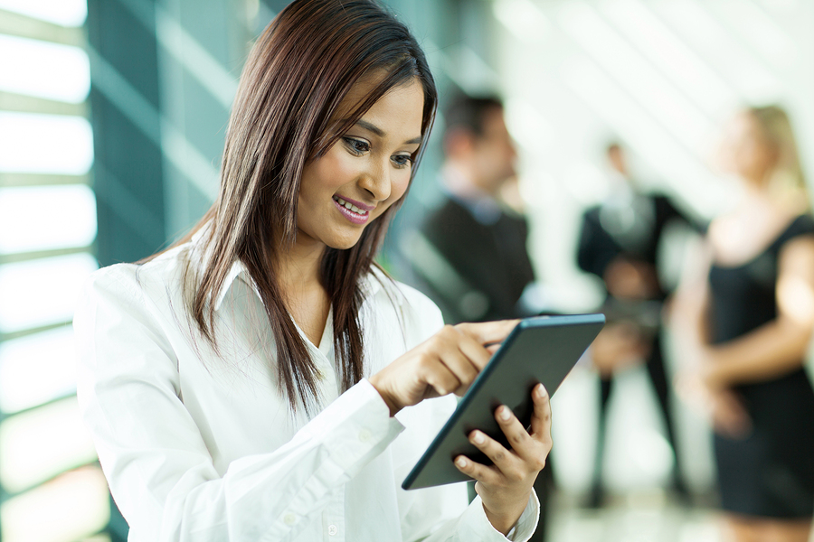 beautiful indian white collar worker using tablet computer in of